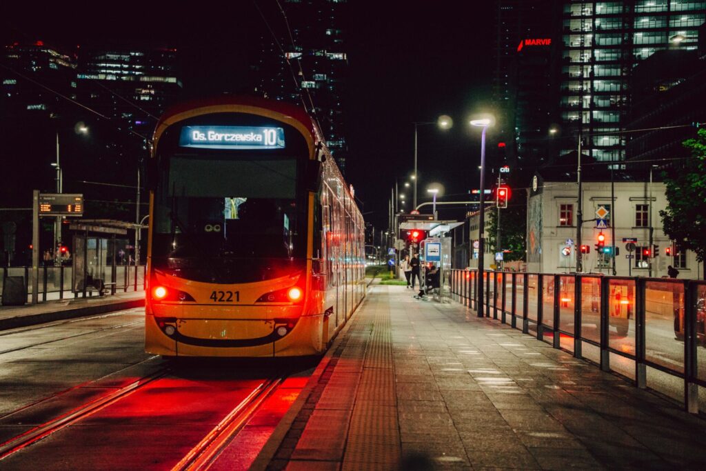 A closeup photo of a tram in Warsaw during evening hours.