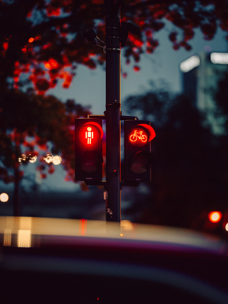 A photo of a street light with a really interesting reflection on the bottom.