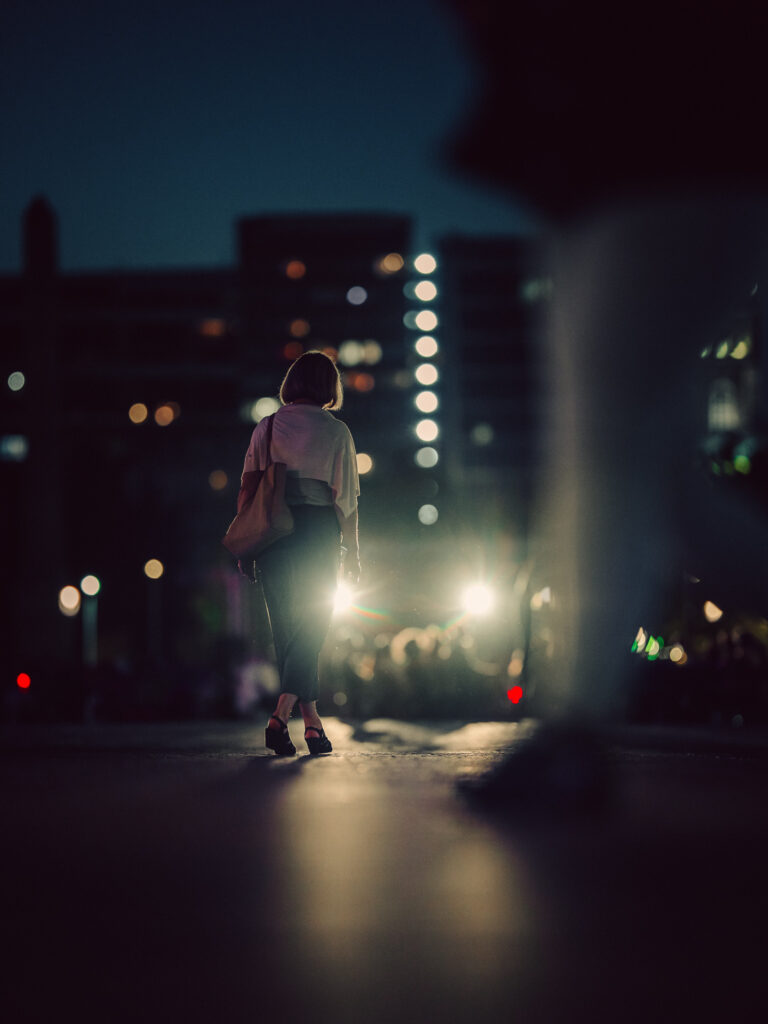 The most cinematic photo of a woman walking on the sidewalk I took using Sigma 135mm.