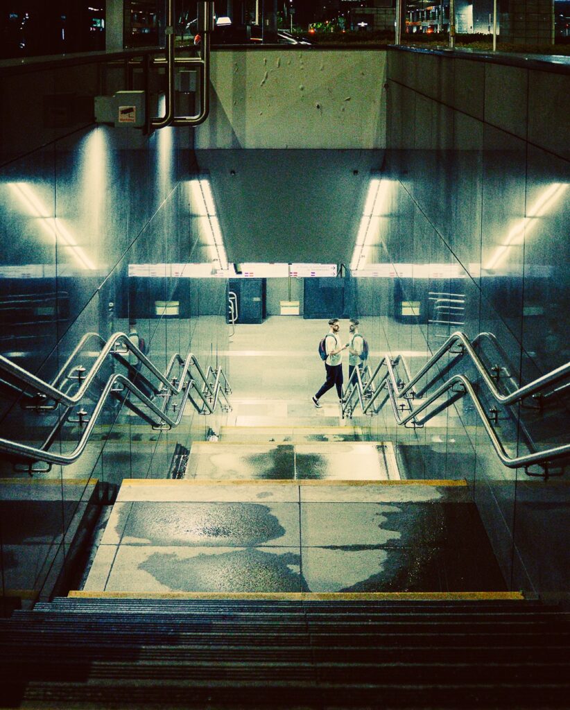 A guy walking down the subway.