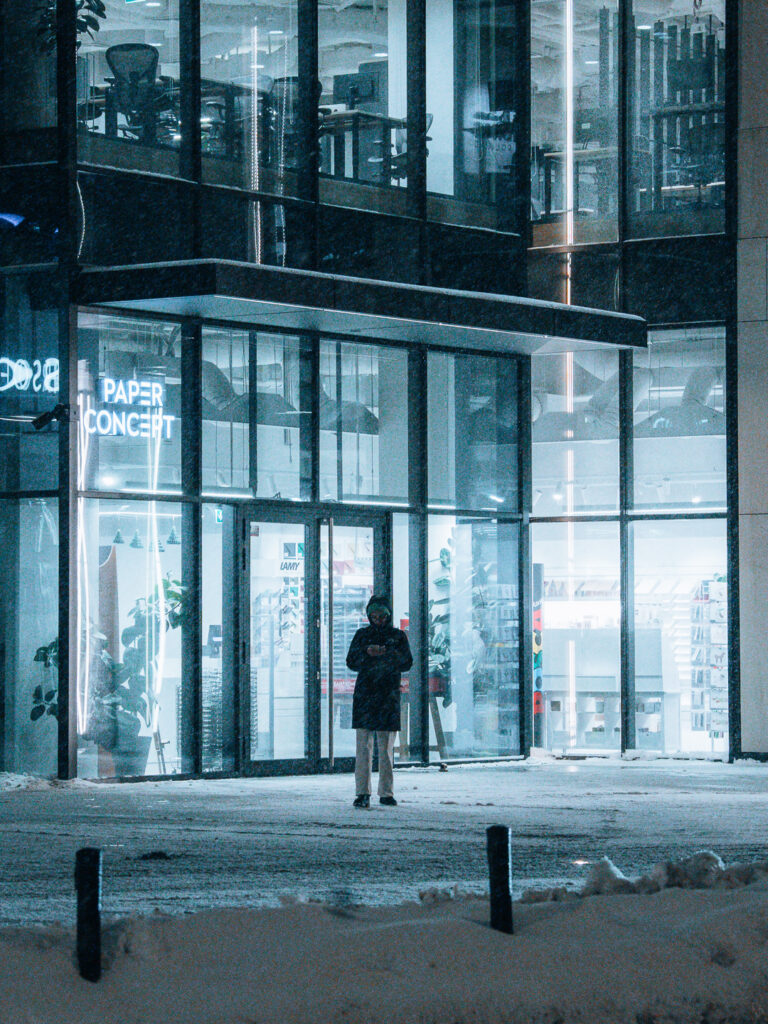 A photo of a woman during a snowfall.