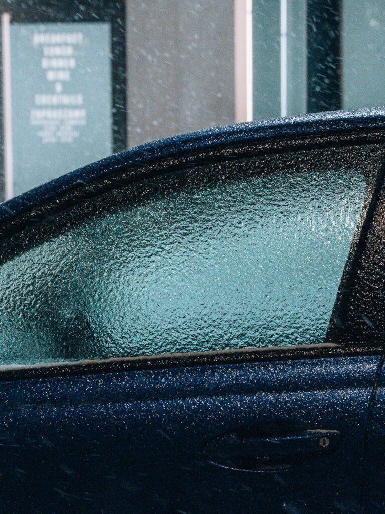 Frozen window of a random car on the street.