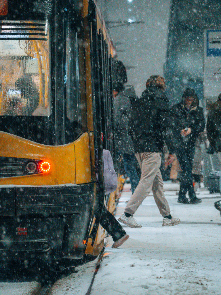 People entering and leaving a tram.
