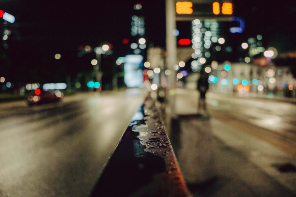 Night cinematic depth of field with a water on a handrail. 