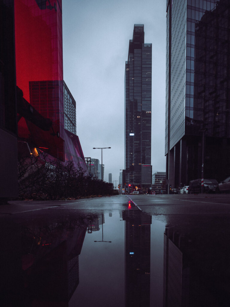 Puddle reflection with skyscrapers in the back.