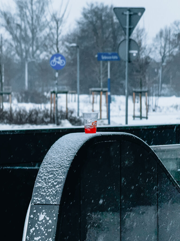 A soda drink covered in snow.