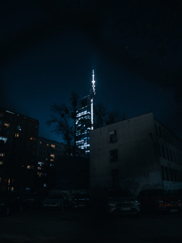 A shot of a tower through a fence.