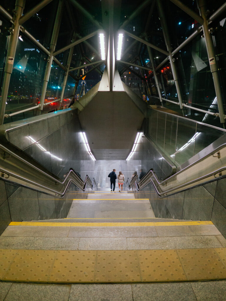 A couple walking down the stairs.