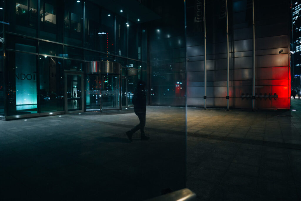 A dark silhouette of a pedestrian taken through the window.