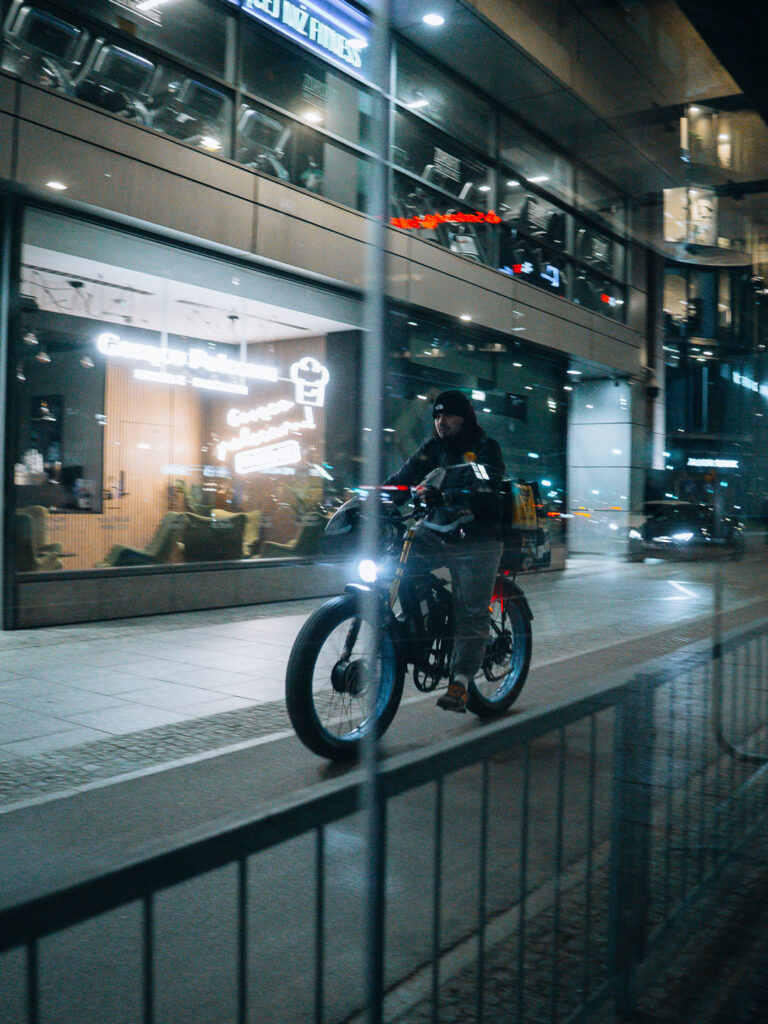 A biker photographed through the window.