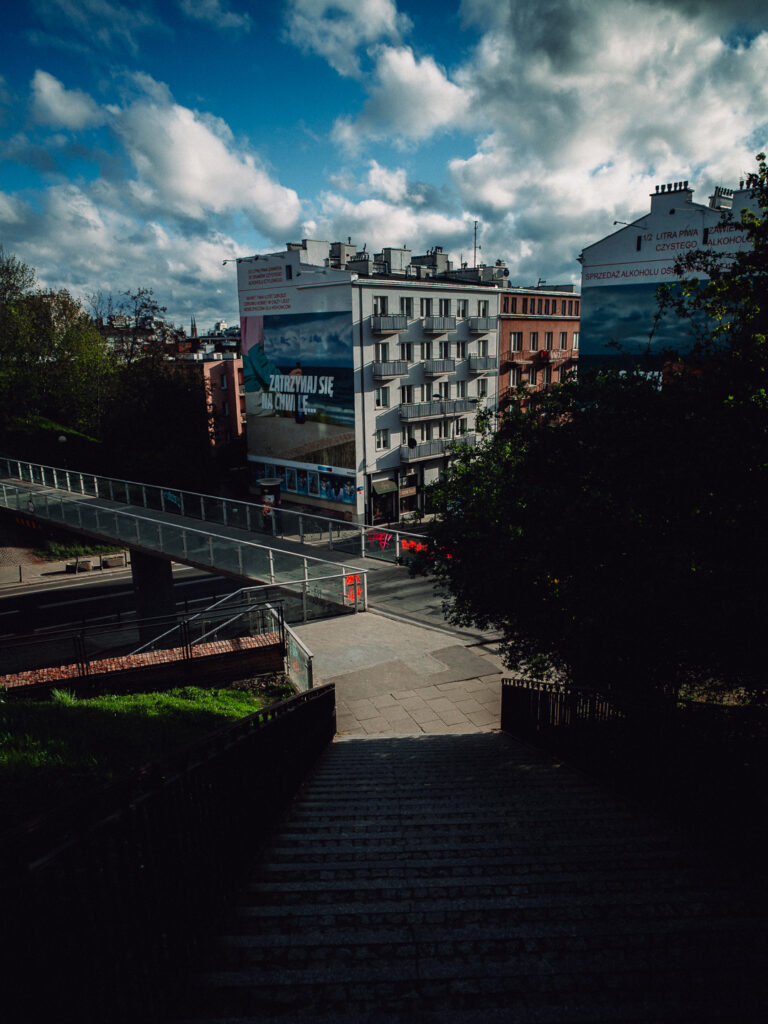 From the top of the stairs with buildings and clouds. Taken with the Brightin Star 24mm F1.8 lens.