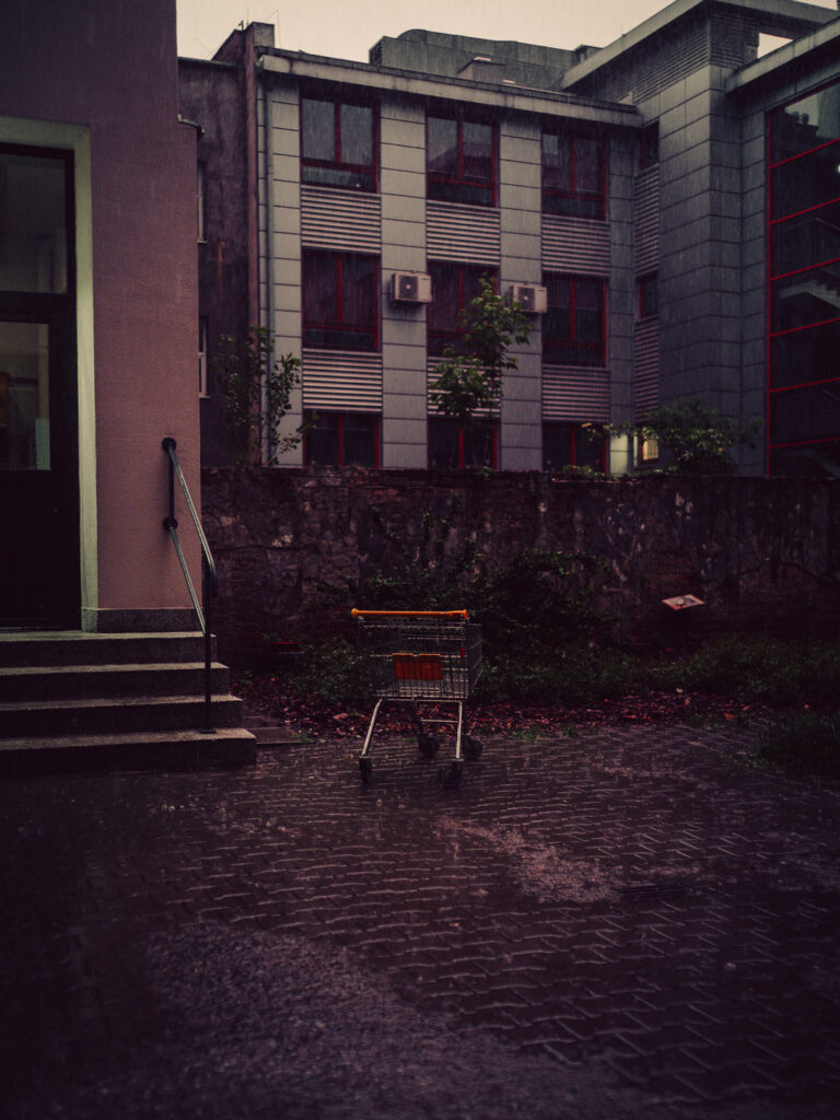 A shopping cart left alone on the street.